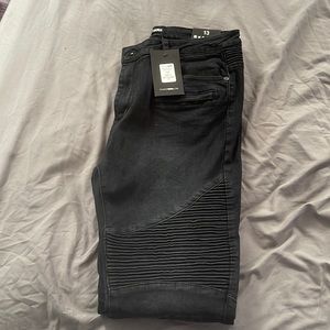 Black skinny leg jeans with rubbed designs